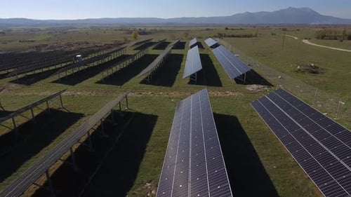 Aerial View of Solar Panel Farm in Rural Landscape