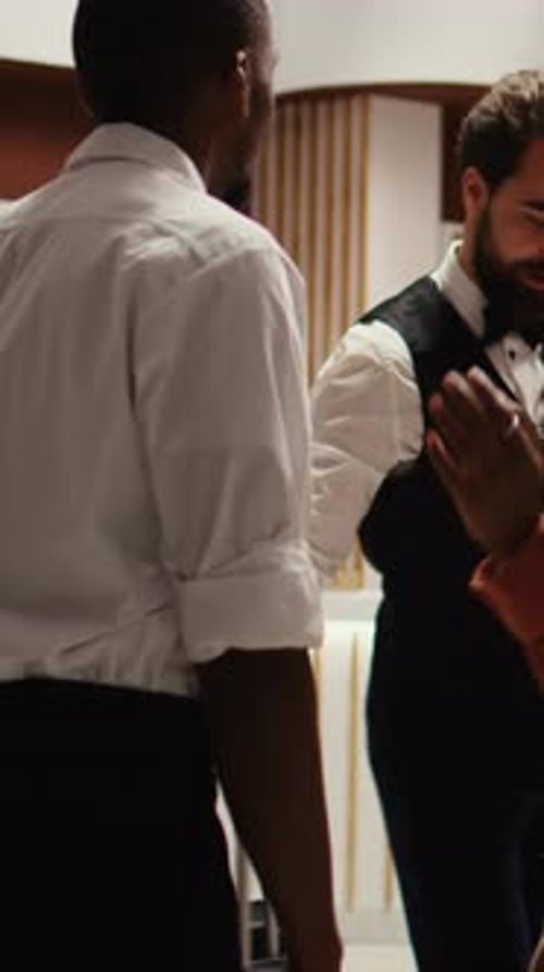 Couple Checking into Hotel at Reception Desk