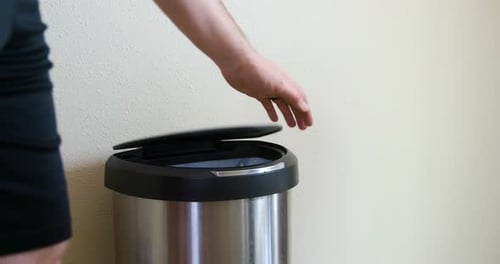 Man Throws Away Old Vegetables in Motion Sensing Touchless Trash Can - Medium Side