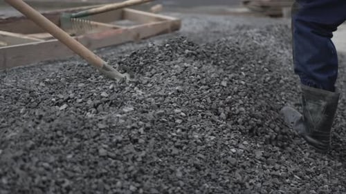 Workers Spread Gravel with Shovels