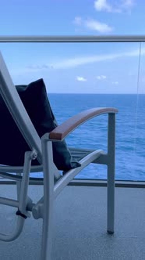 Balcony on Cruise Ship with Ocean View and Chair on Sunny, Peaceful Day, vertical