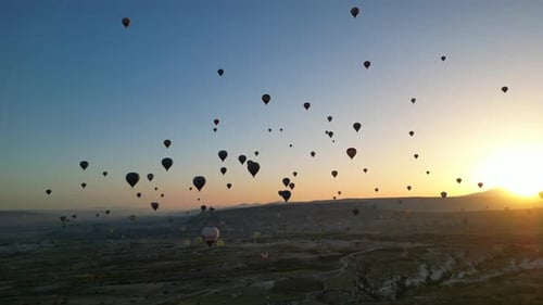 Hot Air Balloons Floating Over Landscape at Sunrise