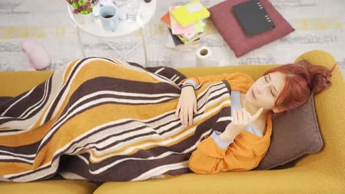 Young Woman with a Cold Lying on Couch