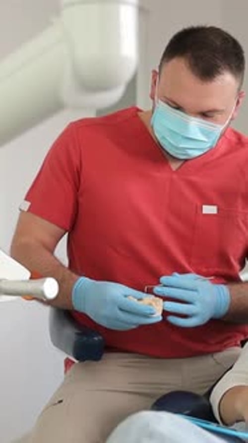 A Young Woman in a Dental Clinic with a Male Dentist Concept of Healthy Teeth Vertical Video