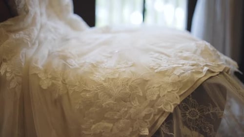 Elegant Wedding Dress Displayed on Chair Close Up