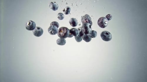 Bilberries falling into water.