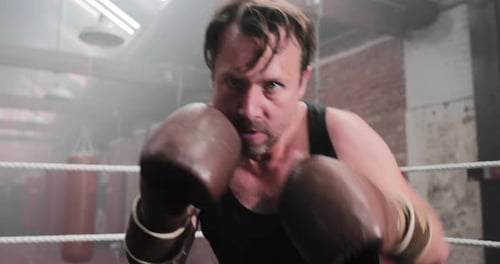 Boxer Punches in Ring Close Up