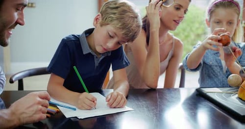 Family Working on School Project at Home