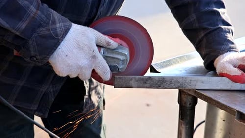 Worker Cuts Metal Beam with Circular Saw