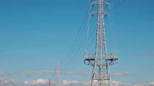Electrical net of poles against the blue sky.