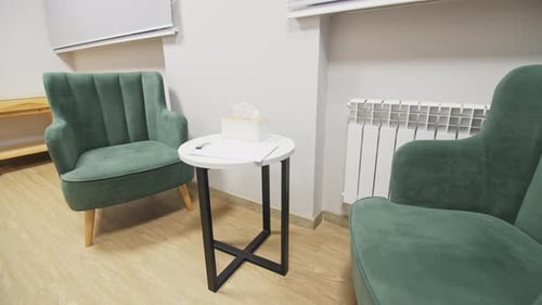 Low Table with Clipboard and Soft Armchairs at Place to Rest