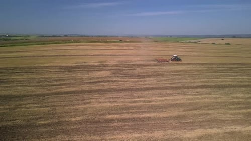 Tractor working on the field doing tillage with cultivator