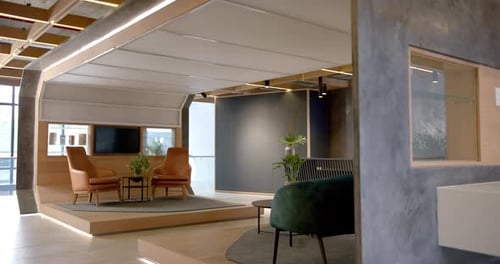 Modern office lounge area with stylish furniture and plants, creating inviting space, copy space