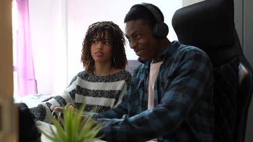 Young Couple Playing Video Games Together at Home