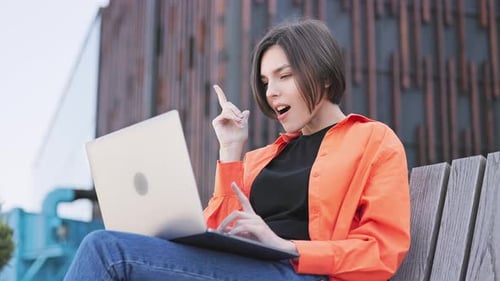 Young Woman Having an Idea While Using Laptop
