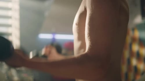 Boy Performing Bicep Curls with Dumbbells Indoors