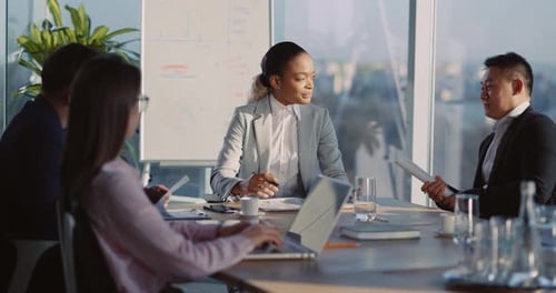 Multiethnic Young and Old Coworkers Meeting in Office Room Talking About Partnership Contract