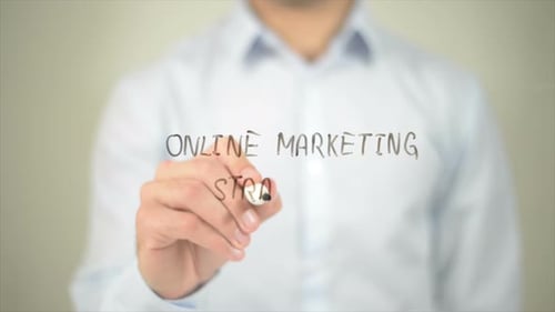 Writing Online Marketing Strategy on Clear Surface