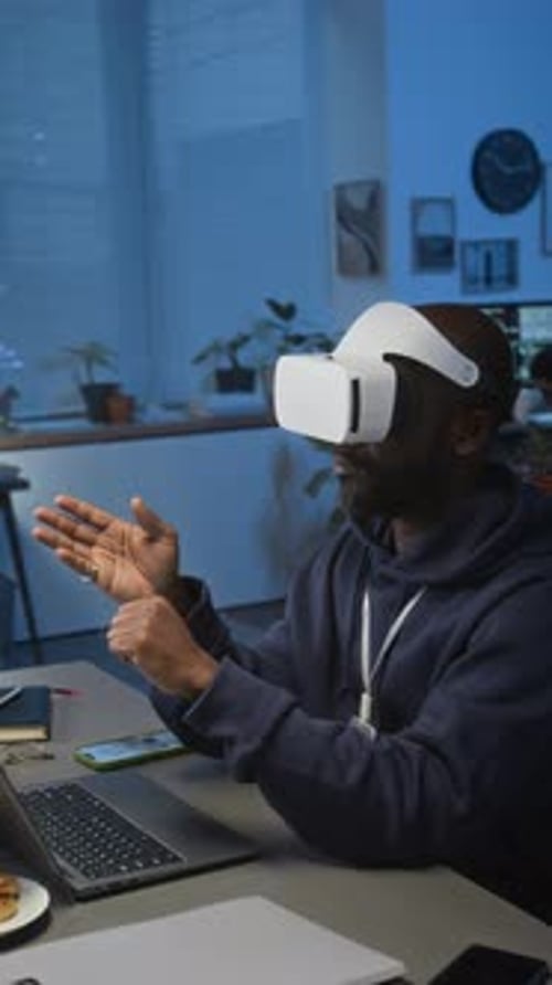 Man Works with VR Headset at Desk