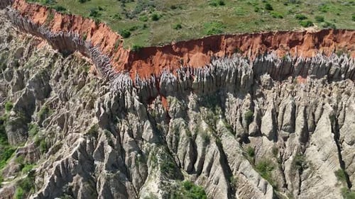 Incredible Aerial View of Dramatic Red Earth Canyons and Cliffs