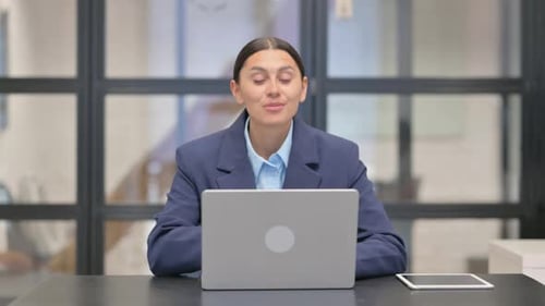 Young Woman in Video Conference in Office