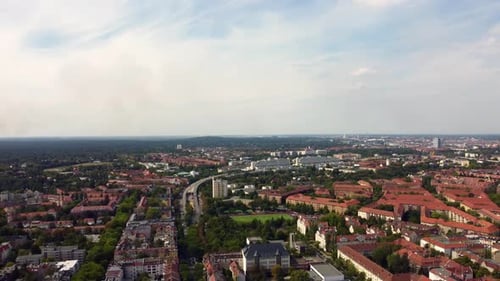 View over Berlin Steglitz to the big wood fire. Dramatic aerial view flight pan from right to left d