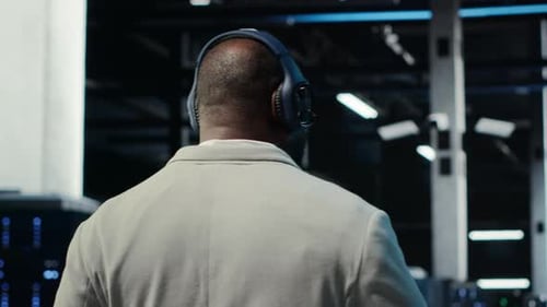 Software Developer in Data Center Workspace Coding on Tablet