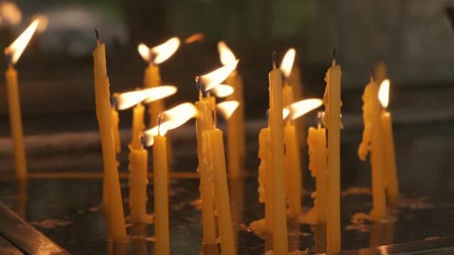 Steady shot of candles burning in a Greek temple