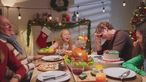 Family Celebrates Christmas Dinner Together at Home