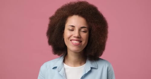 Smiling Attractive African American Woman Standing Over Pink Studio Background