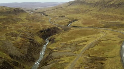 Traffic in the mountains. Drone view of cars travelling in the mountains.