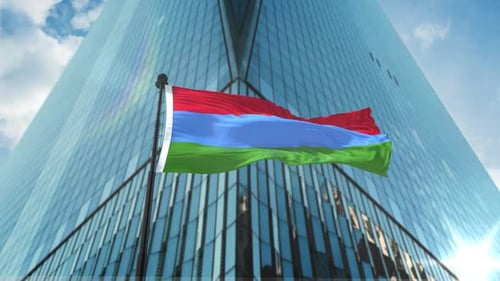 Realistic Waving Flag on Pole with Corporate Skyscraper Background