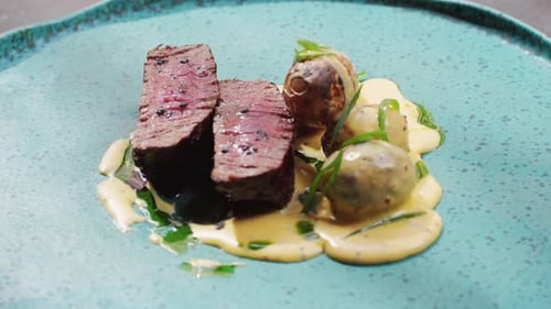 Juicy Medium Beef Meat Rib Eye Steak Slices with Baked Potato in Expensive Modern Fusion Restaurant