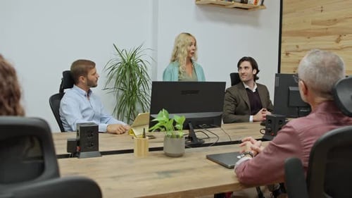 Businesswoman Guiding a Productive Office Meeting with Her Team Business Concept