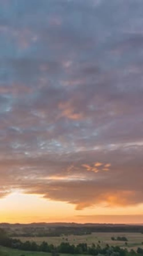 Golden Sunrise Over Rolling Rural Landscape