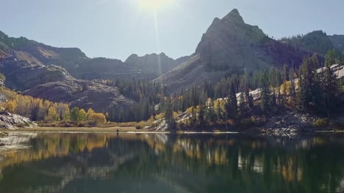 Aerial drone shot of Lake Blanche in Utah’s Big Cottonwood Canyon. The camera trucks left, showing g