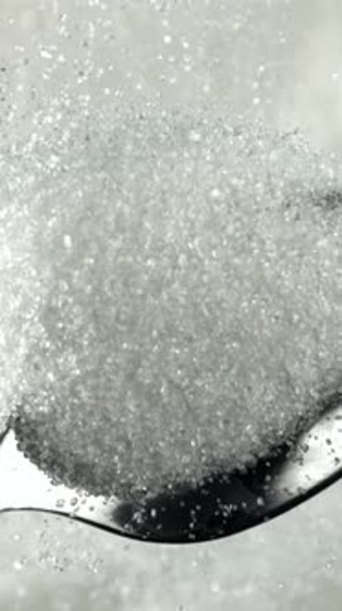 Sugar Pours Out of a Spoon Filmed on a Highspeed Camera at 1000 Fps