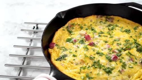 Freshly Baked Spinach and Ham Frittata in Cast Iron Skillet