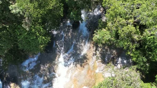 Tranquil view of water's gentle cascade in the forest.