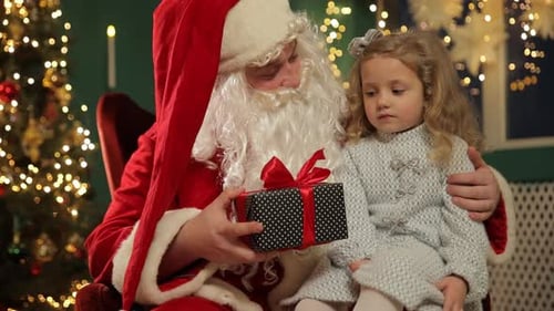 Santa Claus with a Girl Holding a Christmas Gift