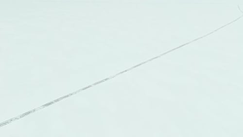 Top shot of a ice road, a path on frozen lake or sea ice, used to travel fast via car or walking acr