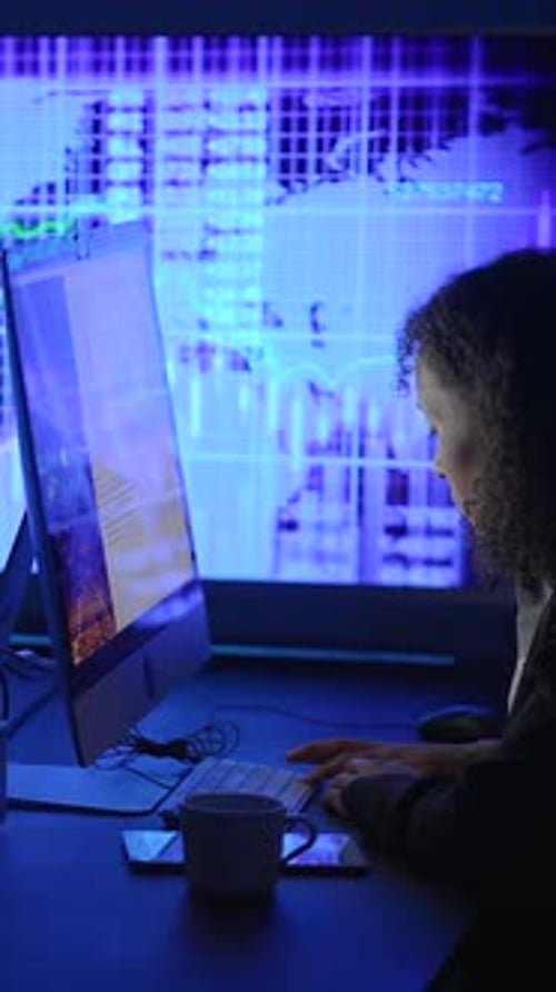 Dedicated and Focused Professional Engaged in Analyzing Data on a Computer Screen