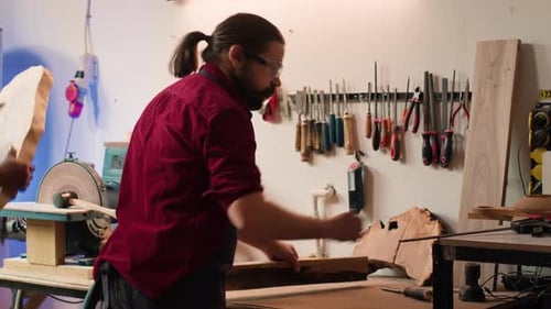 Woodworker Measuring Wood at His Workbench