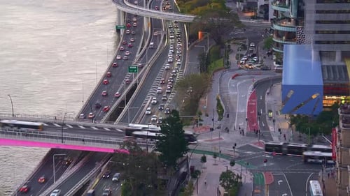 Time-lapse shot of buses entering and exiting Victoria Bridge, with peak-hour traffic motion on the