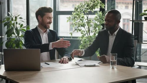 Two Diverse Businessmen at Office Meeting Shake Hands After Successful Business Contract Agreement