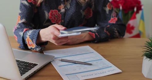 Woman Hands Passport Tickets at Travel Agency
