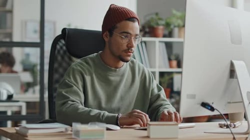 Young Programmer Working with Program on Computer
