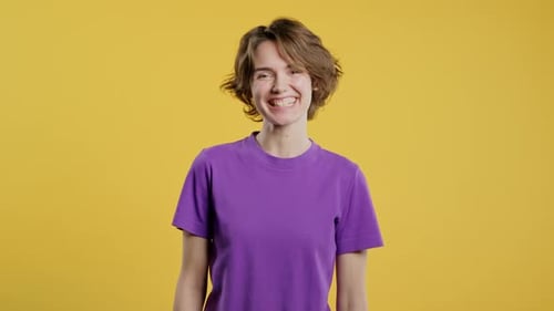 Friendly Young Woman Showing Yes Signal approvePositive Smiling Lady on Yellow