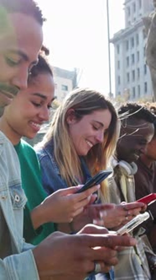 Young Adults Using Phones in Urban Setting
