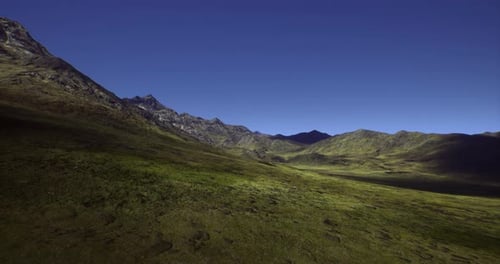 Majestic Green Valley Under a Clear Blue Sky in the Mountains